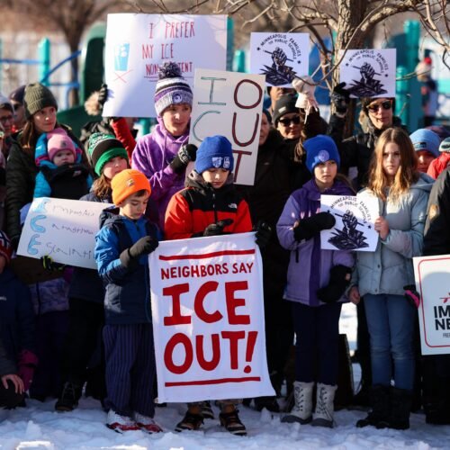 People pause for a minute of silence during a press conference organized by the group "Minneapolis Families for Public Schools," in Minneapolis, Minnesota, on January 9, 2026. A US Immigration and Customs Enforcement (ICE) agent shot and killed an American woman on the streets of Minneapolis January 7, leading to huge protests and outrage from local leaders who rejected White House claims she was a domestic terrorist. The woman, identified in local media as 37-year-old Renee Nicole Good, was hit at point blank range as she apparently tried to drive away from agents who were crowding around her car, which they said was blocking their way. (Photo by CHARLY TRIBALLEAU / AFP via Getty Images)